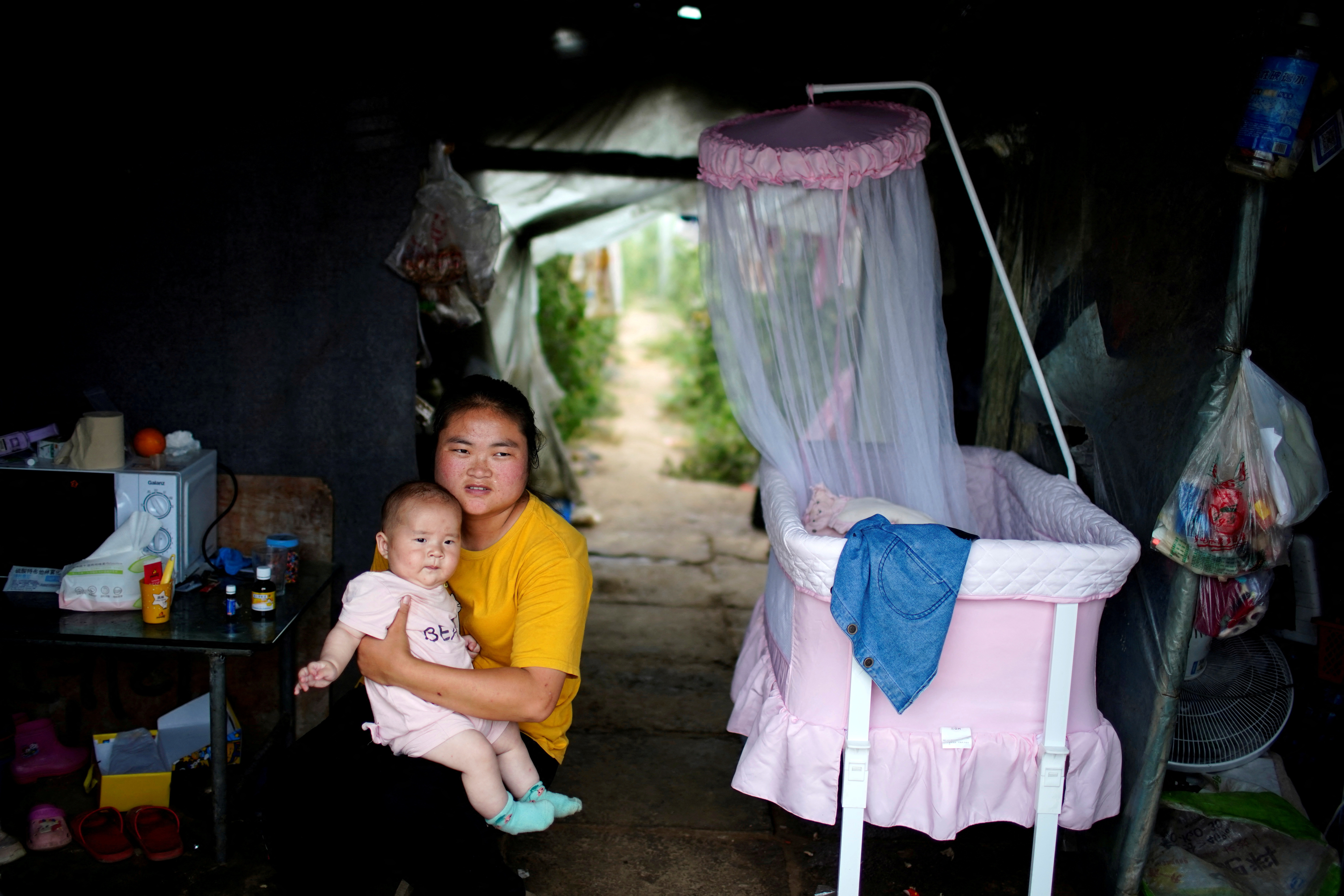 FILE PHOTO: Wang Dan, poses for her 5-month-old baby in Shanghai
