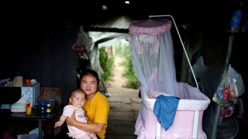 FILE PHOTO: Wang Dan, poses for her 5-month-old baby in Shanghai