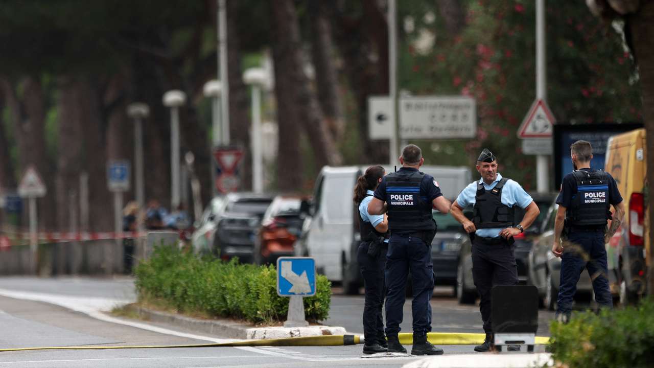 French police stand guard after cars were set on fire in front of the city's synagogue, in La Grande-Motte