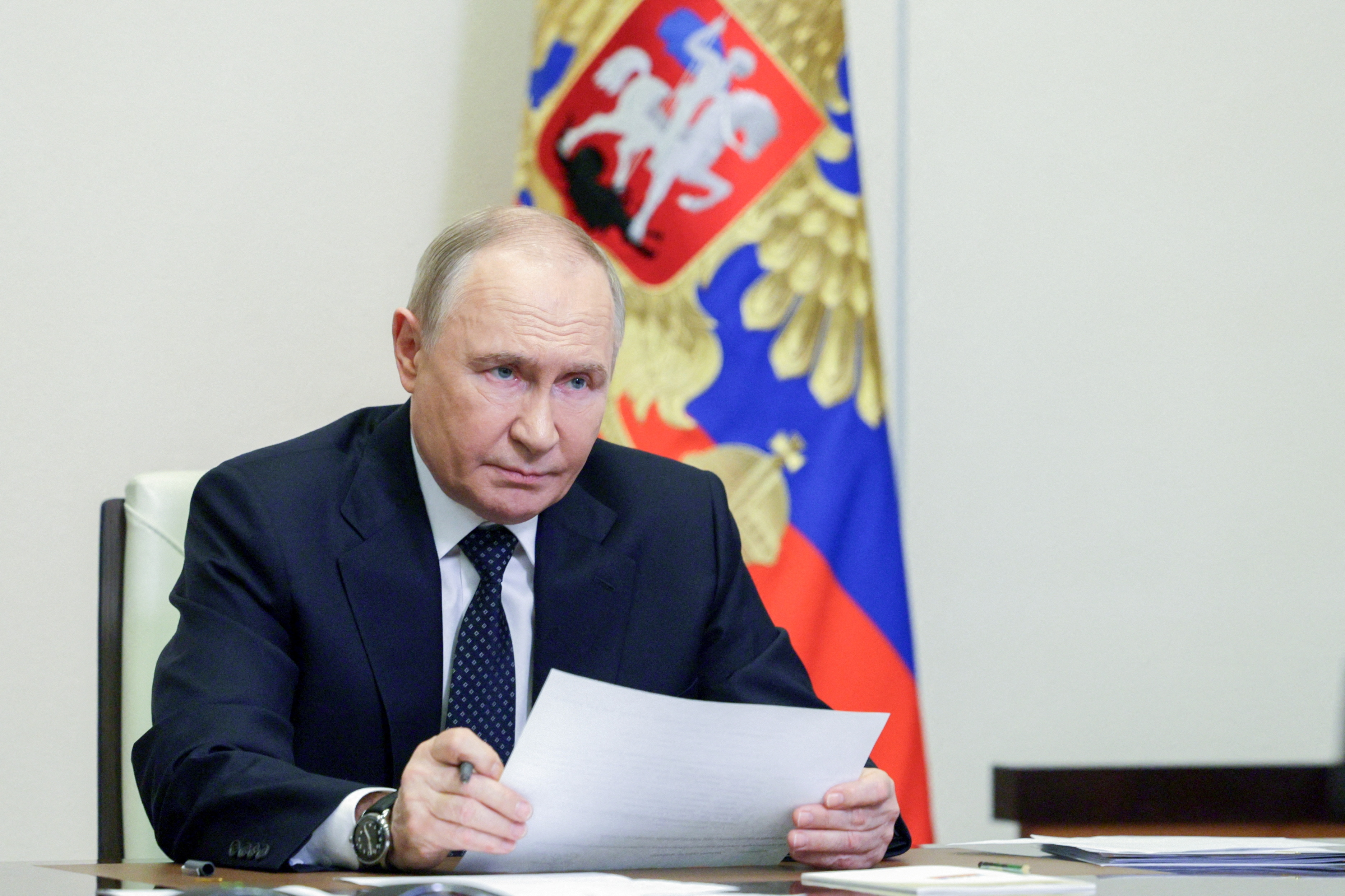 Russian President Putin chairs a meeting with members of the government via video link at a residence outside Moscow