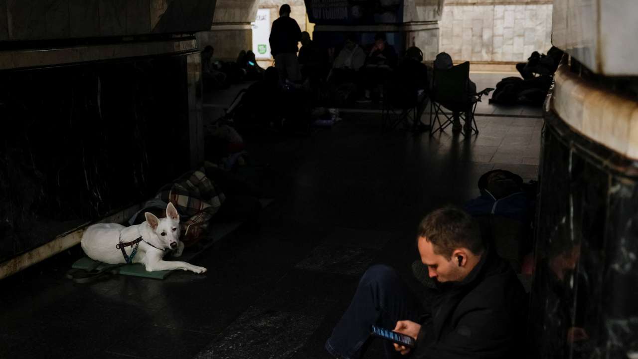 People take shelter inside a metro station during a Russian military attack, in Kyiv
