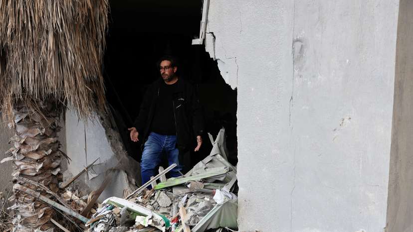 A resident of Baalbek, Hamza al Outa, stands in his destroyed kitchen, in Baalbek