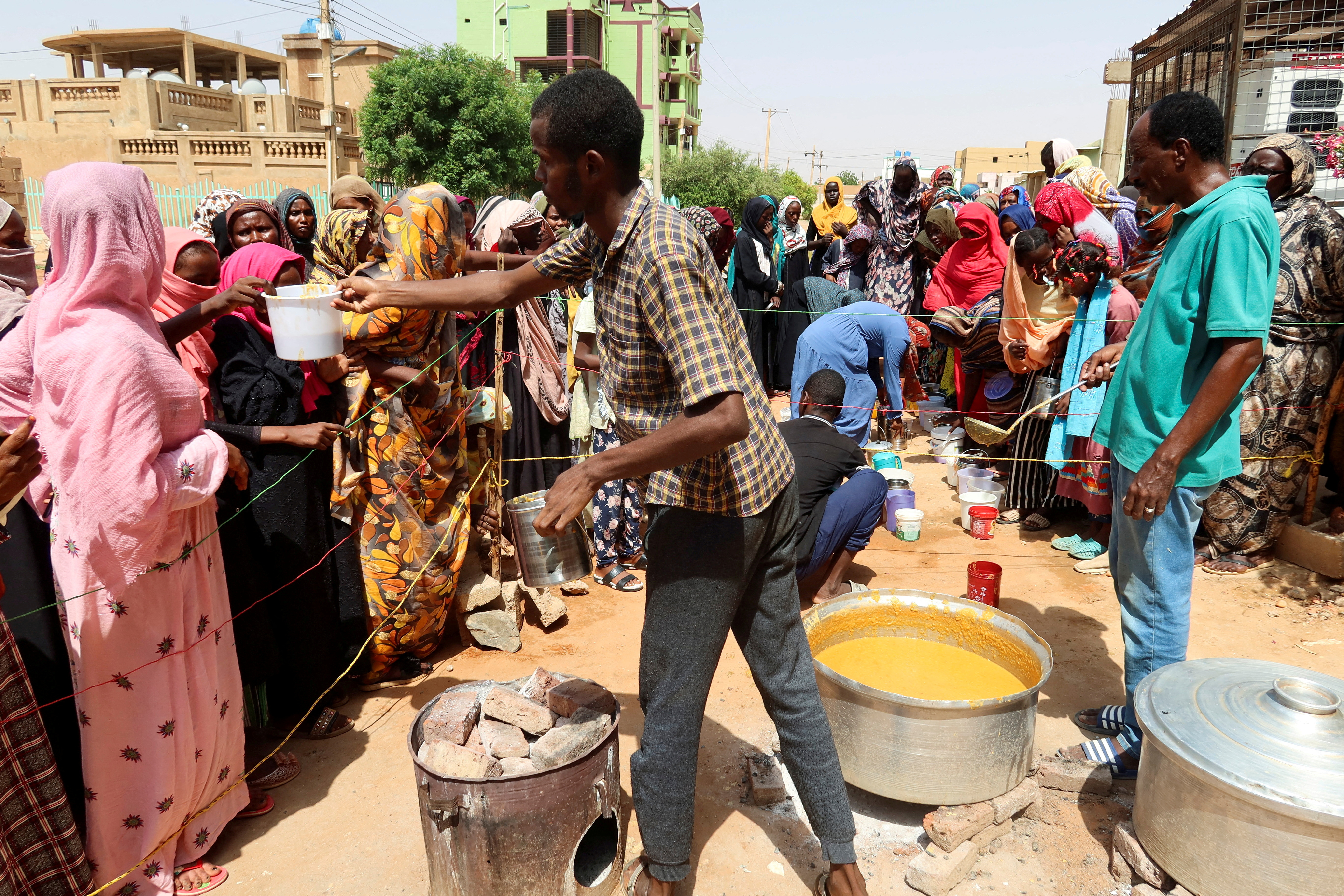 FILE PHOTO: Volunteer distributes food to people in Omdurman