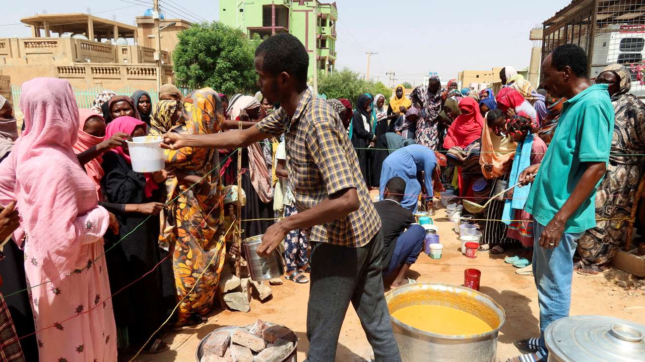 FILE PHOTO: Volunteer distributes food to people in Omdurman