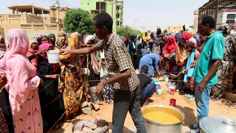 FILE PHOTO: Volunteer distributes food to people in Omdurman