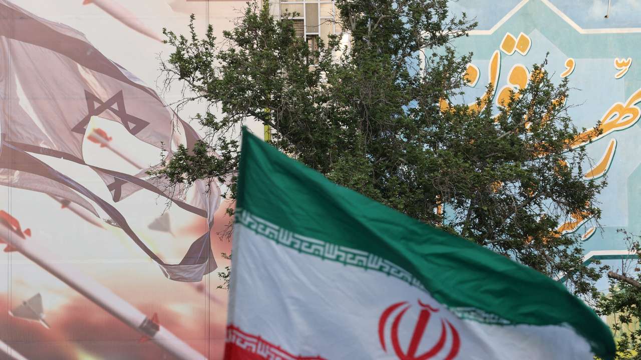 FILE PHOTO: An anti-Israel billboard is seen next to the Iranian flag during a celebration following the IRGC attack on Israel, in Tehran