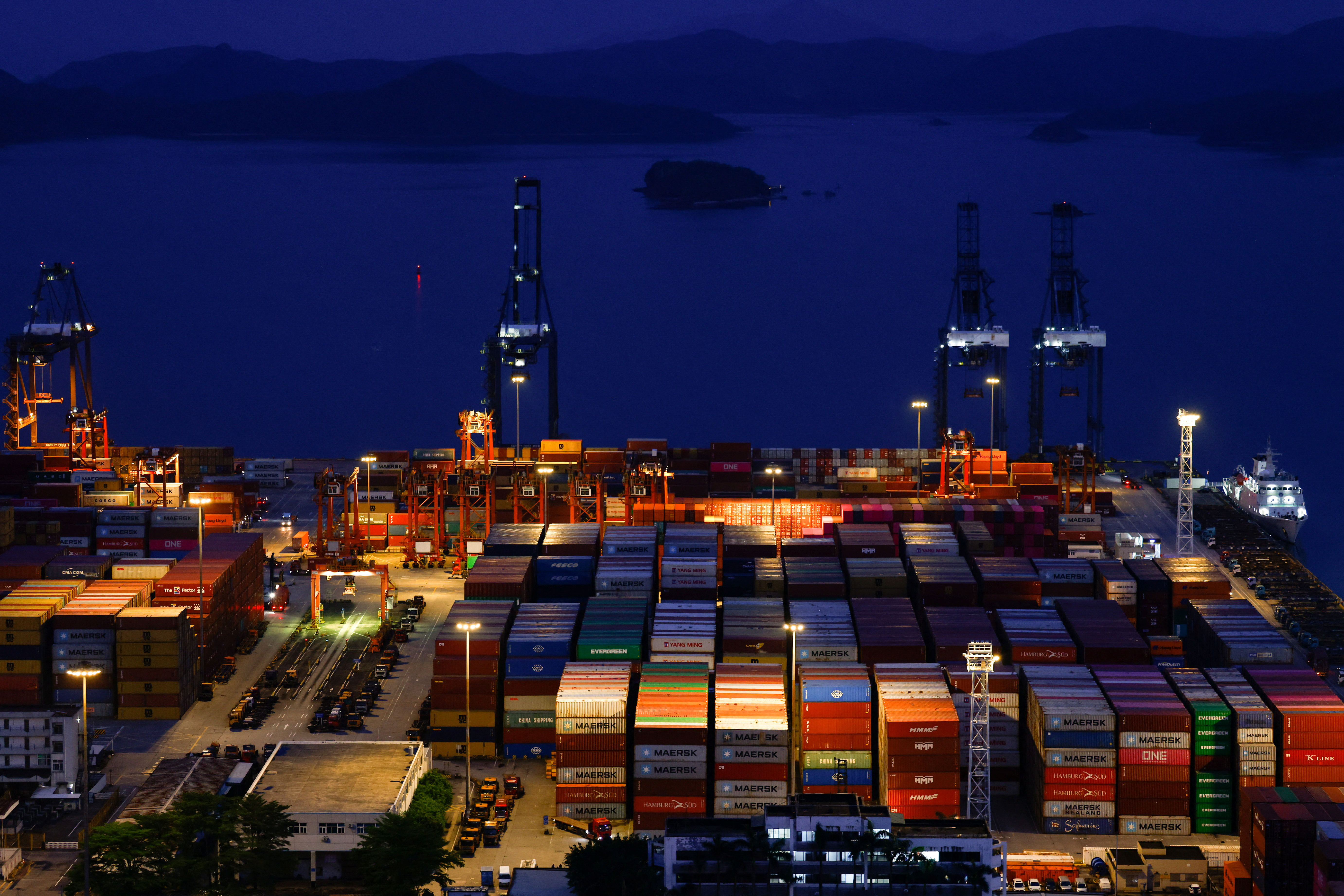 Truck carrying containers move at Yantian port in Shenzhen, Guangdong