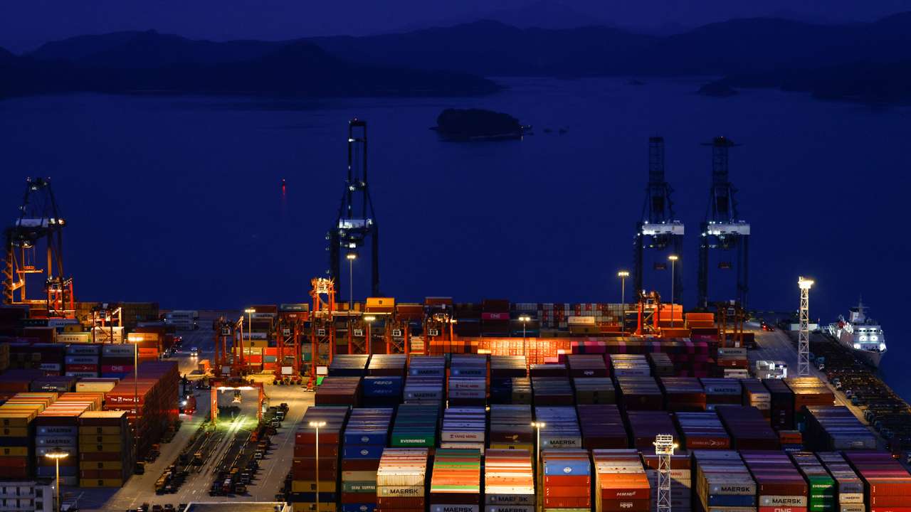 Truck carrying containers move at Yantian port in Shenzhen, Guangdong