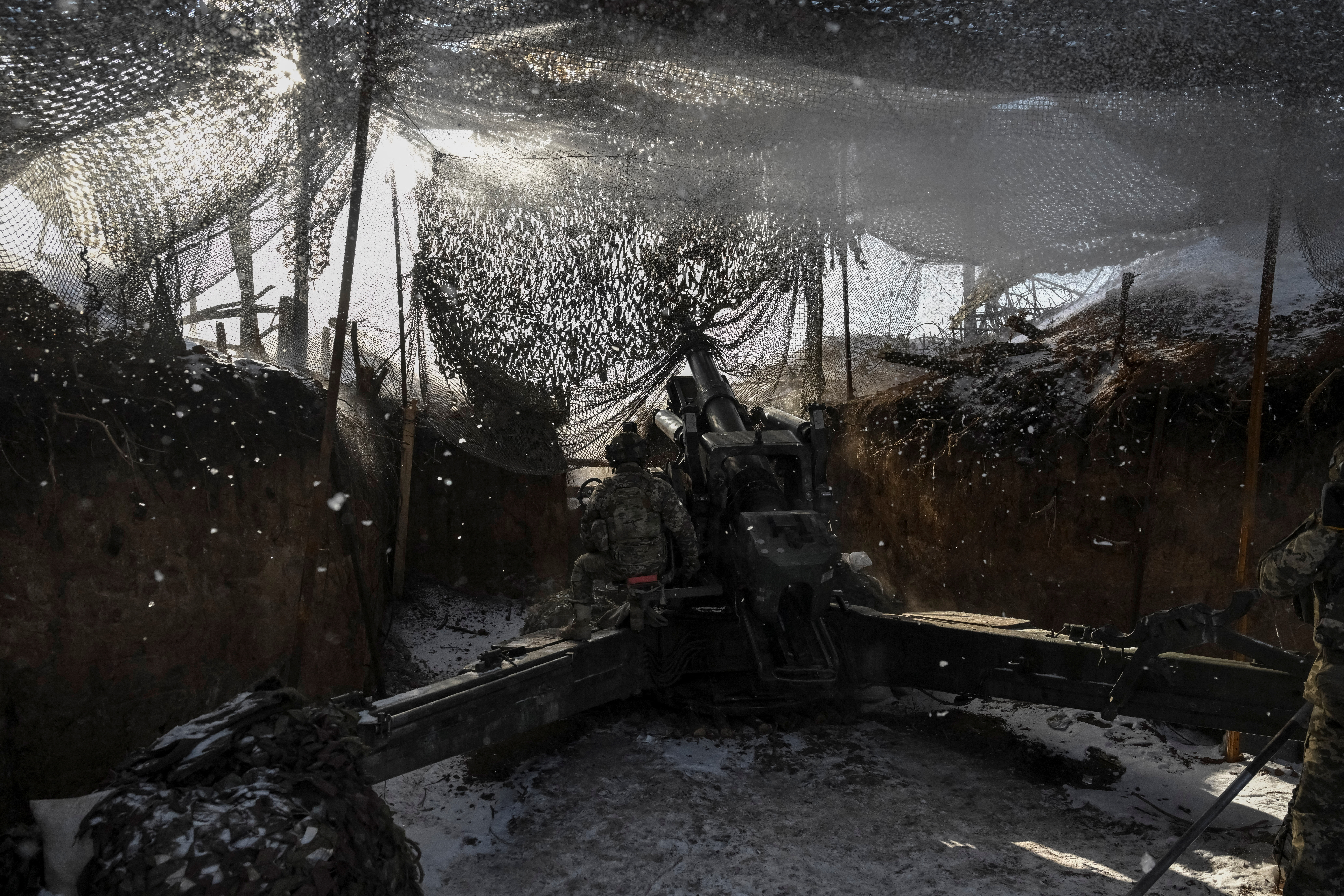Ukrainian servicemen fire a howitzer towards Russian troops at a frontline in Zaporizhzhia region