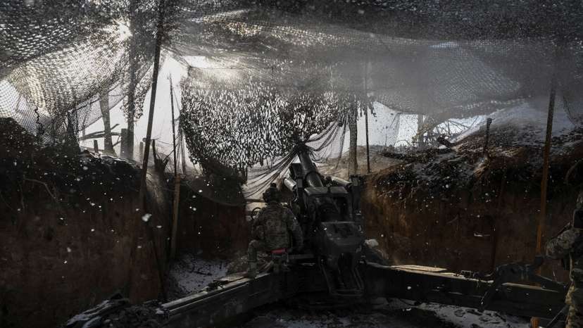 Ukrainian servicemen fire a howitzer towards Russian troops at a frontline in Zaporizhzhia region