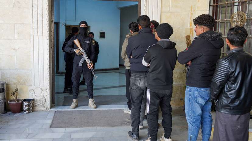 Members of the Kurdish-led Syrian Democratic Forces (SDF) queue to settle their status with Syrian government in Raqqa