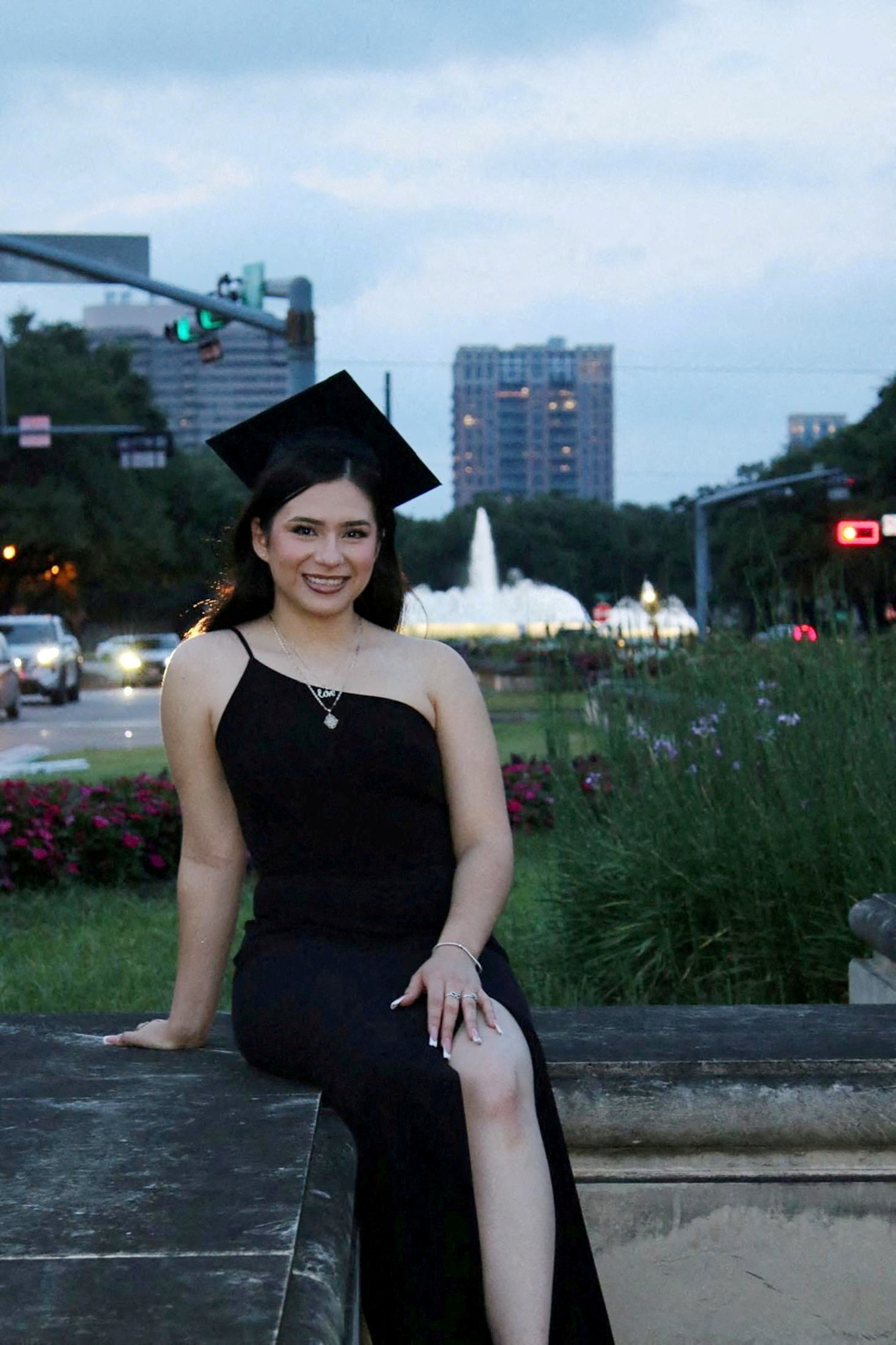 Babson College student Any Lucia Lopez Belloza poses wearing a mortarboard after graduating from high school in Boston