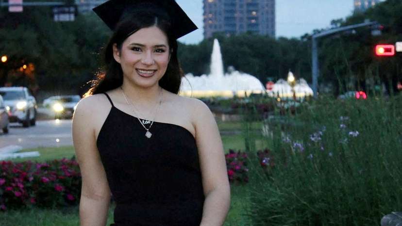 Babson College student Any Lucia Lopez Belloza poses wearing a mortarboard after graduating from high school in Boston