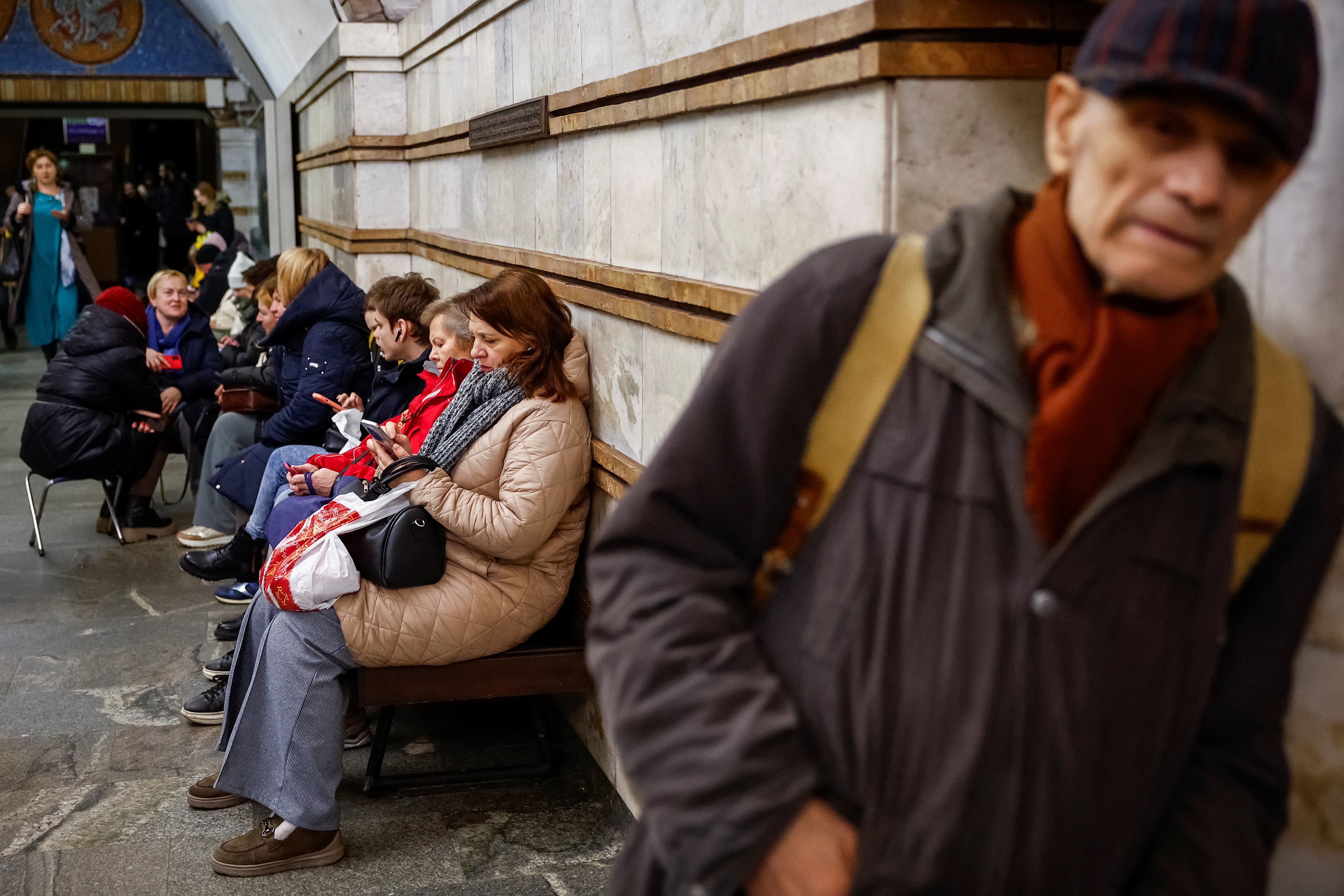 People take shelter inside a metro station during a Russian missile attack, in Kyiv