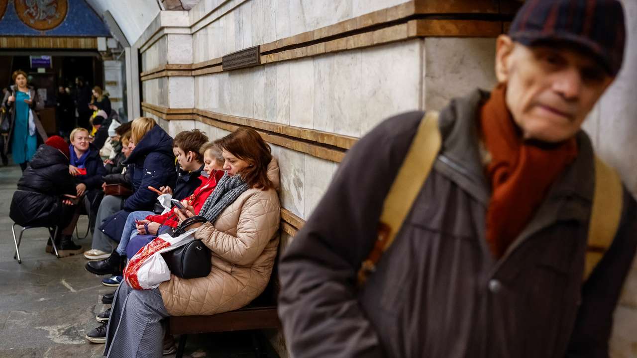 People take shelter inside a metro station during a Russian missile attack, in Kyiv