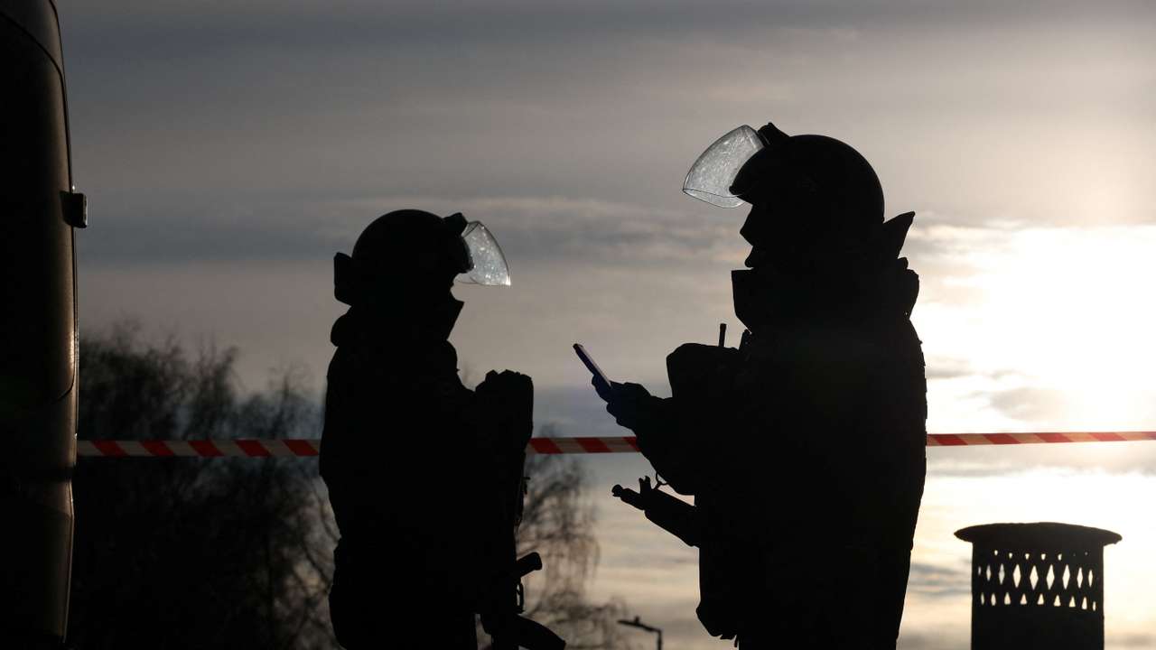 Law enforcement officers work near the site of a blast in Moscow