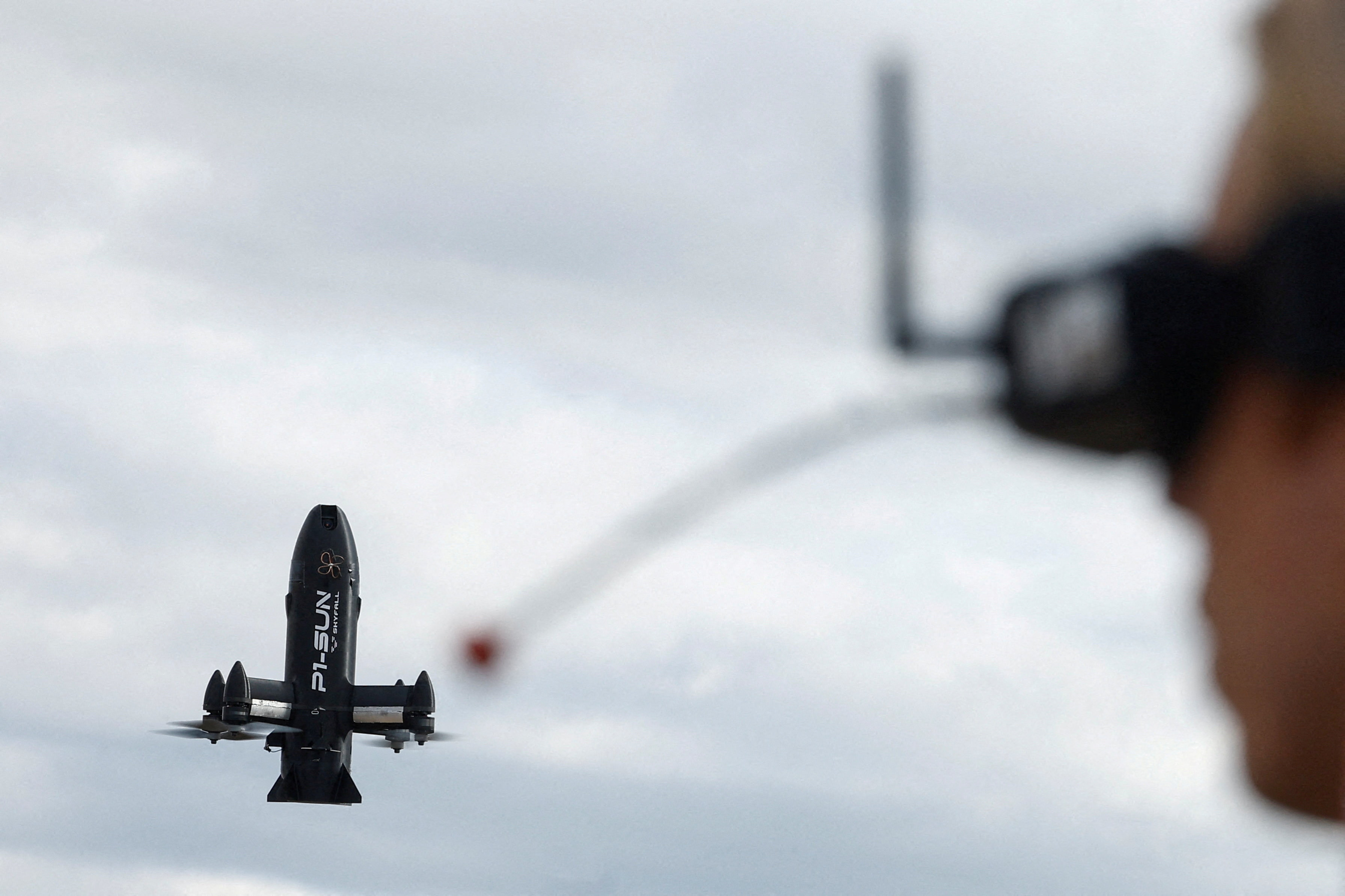 Employee of SkyFall company operates a P1-Sun FPV interceptor drone during a test fly at a training ground in an undisclosed location in Ukraine