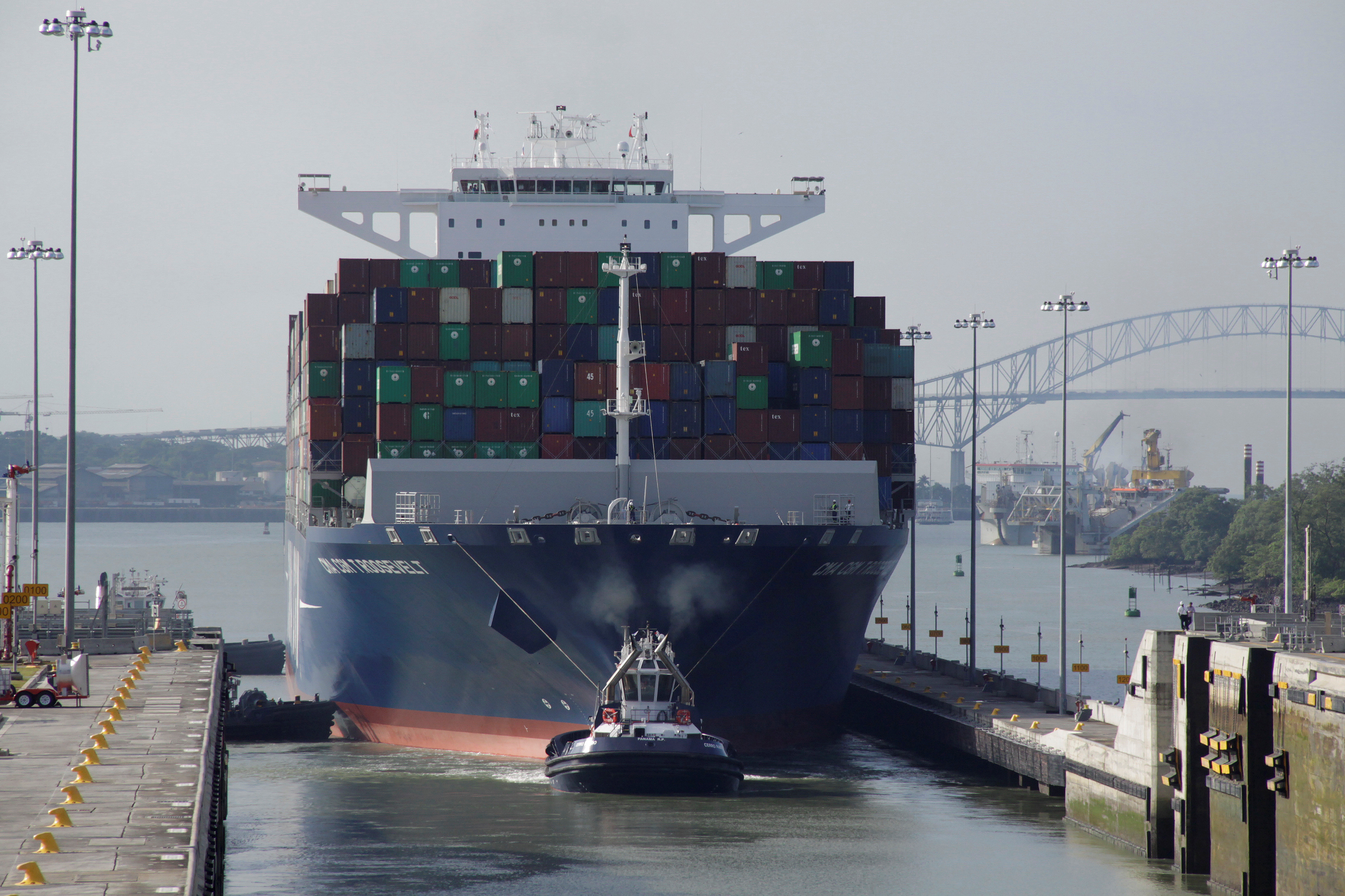 Tugboat tows a cargo vessel at Panama Canal