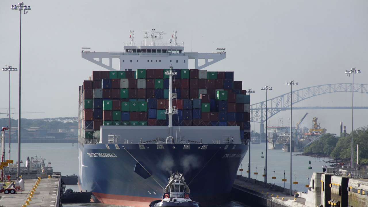 Tugboat tows a cargo vessel at Panama Canal