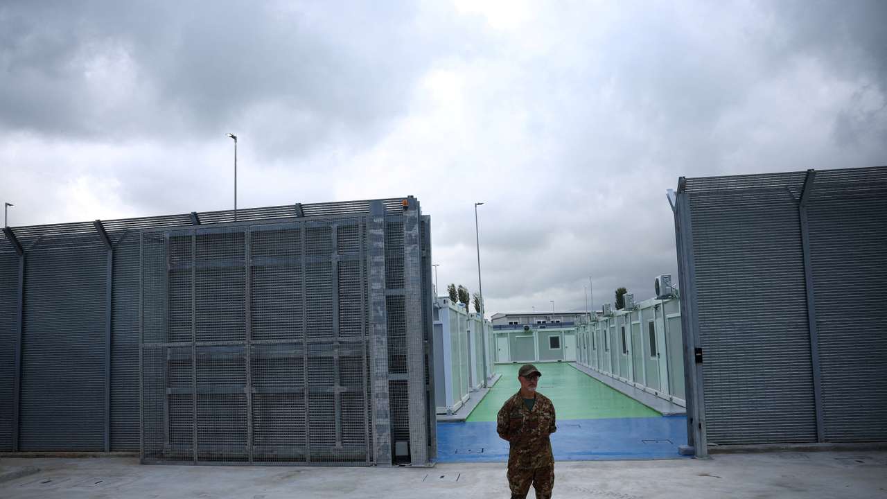 FILE PHOTO: A member of Italian Army stands at a camp for illegal migrants in Gjader