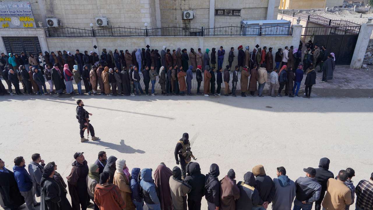 Members of the Kurdish-led Syrian Democratic Forces (SDF) queue to settle their status with Syrian government in Raqqa