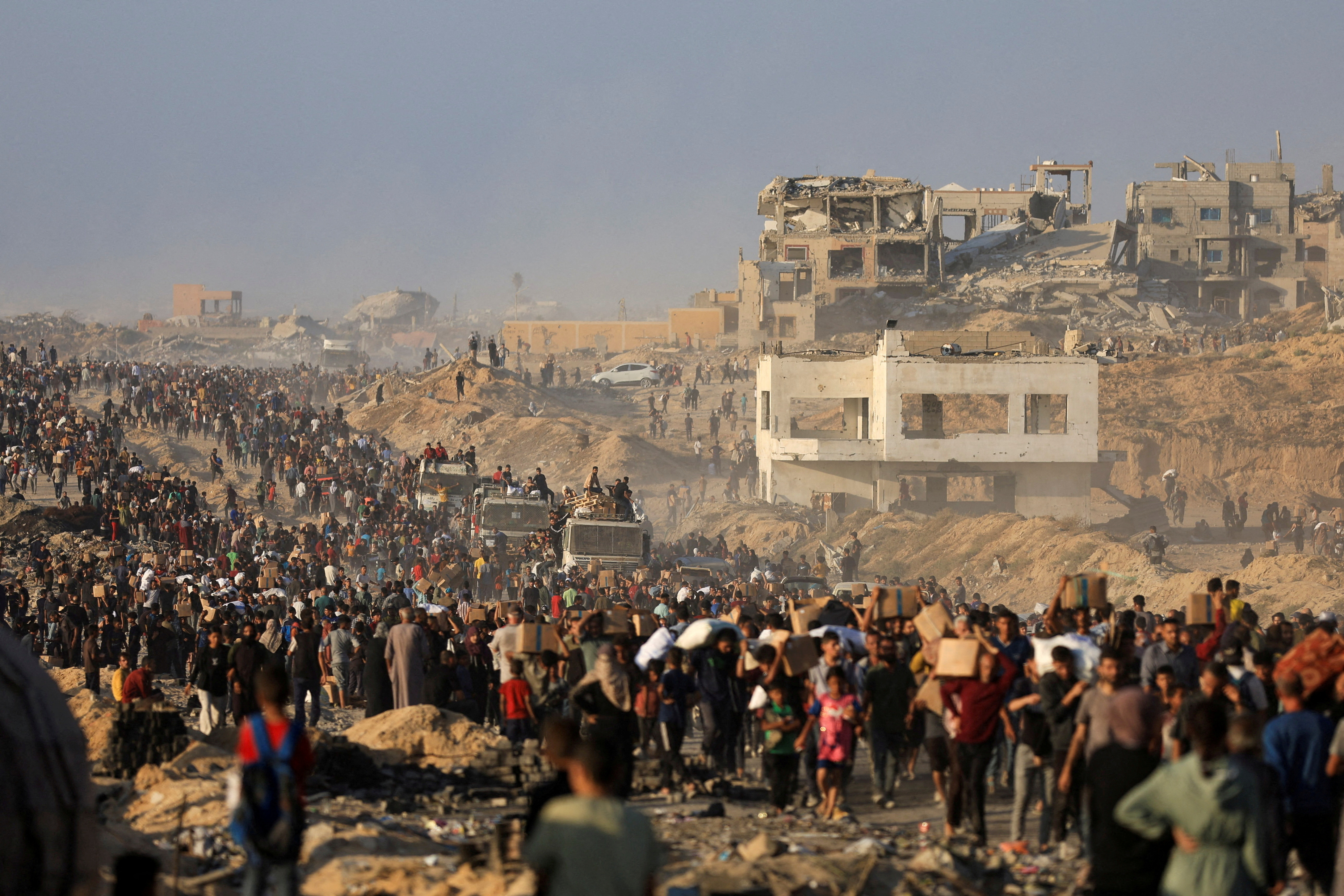 FILE PHOTO: Palestinians receive aid supplies in Beit Lahia