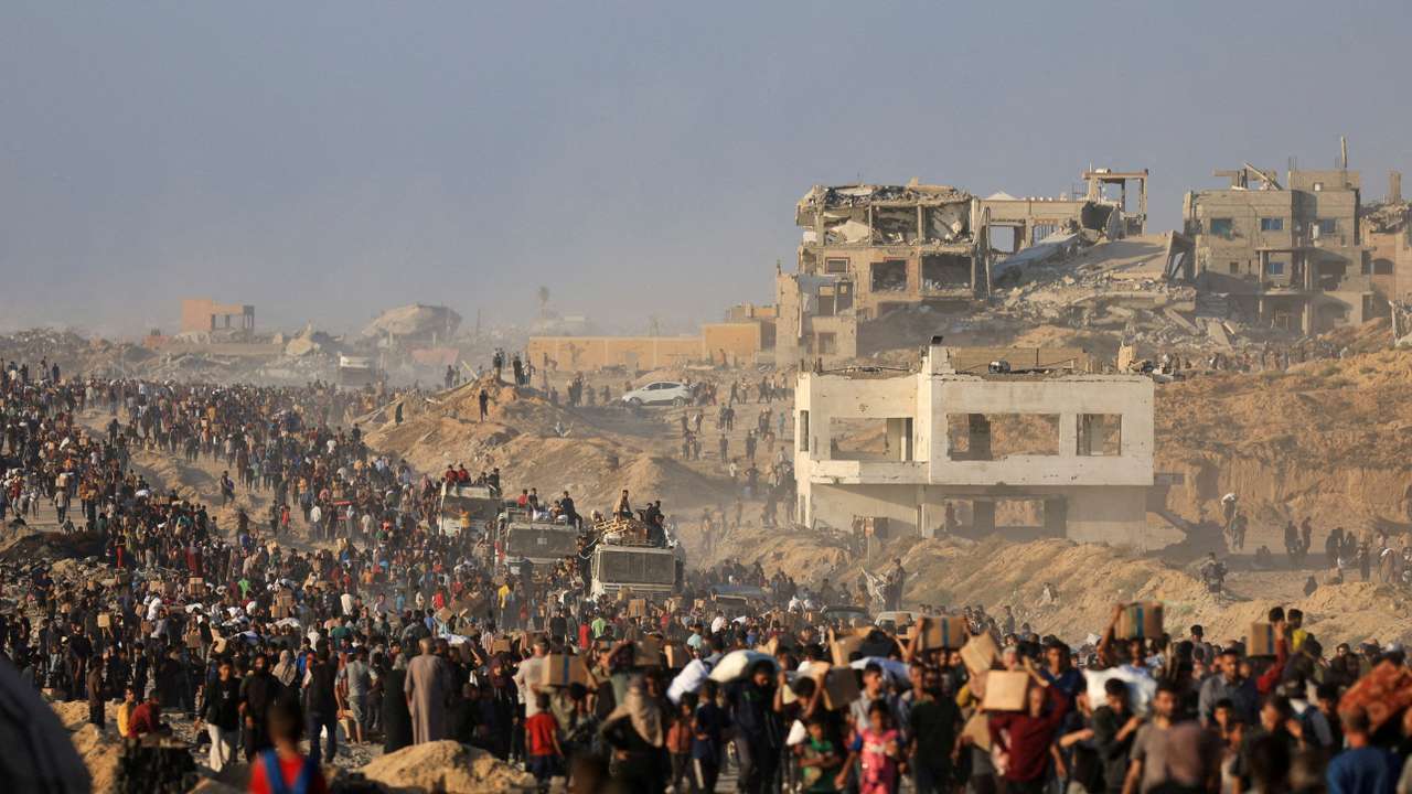 FILE PHOTO: Palestinians receive aid supplies in Beit Lahia