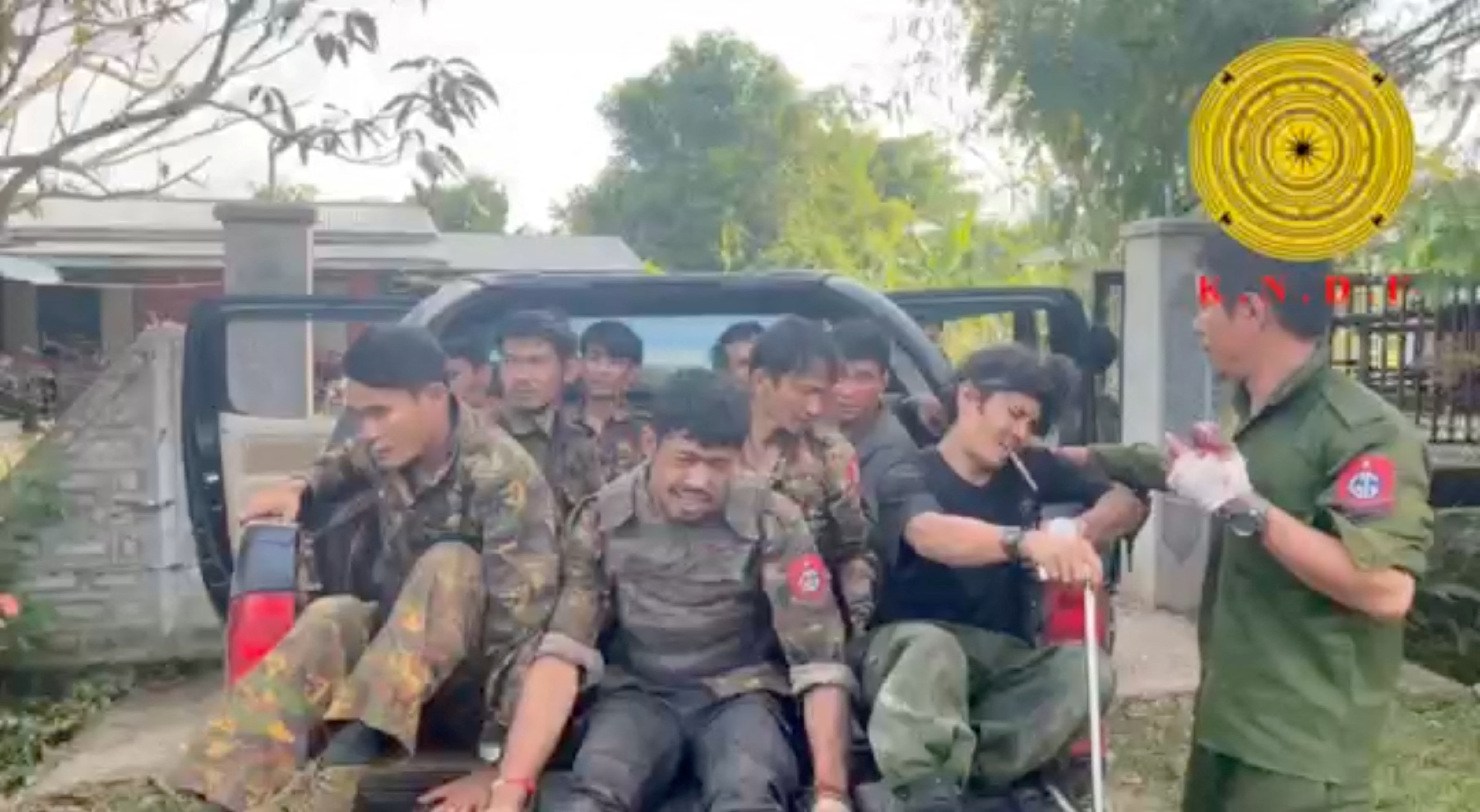Myanmar military soldiers who have surrendered to the Karenni Nationalities Defense Force ride in the back of a vehicle in Loikaw