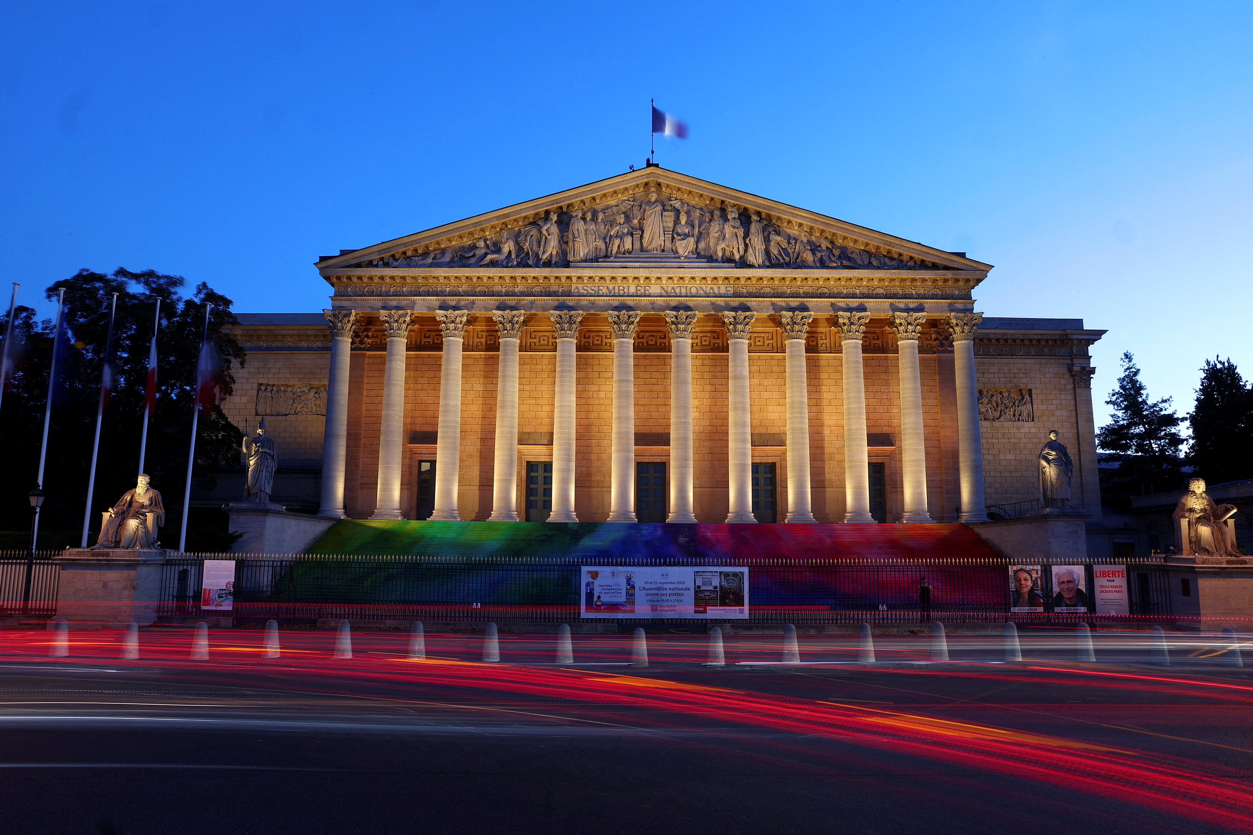 A French flag flutters on top of the National Assembly in Paris