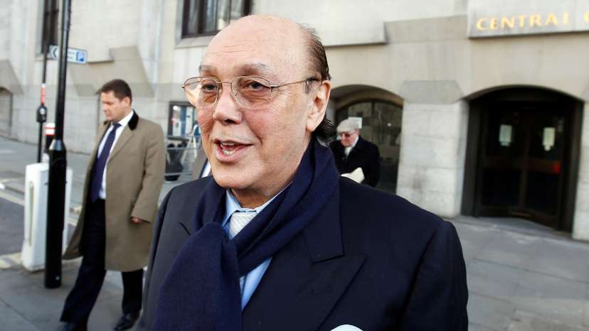 Turkish Cypriot businessman Asil Nadir (R) leaves the Old Bailey courthouse after pleading not guilty to 13 charges in London