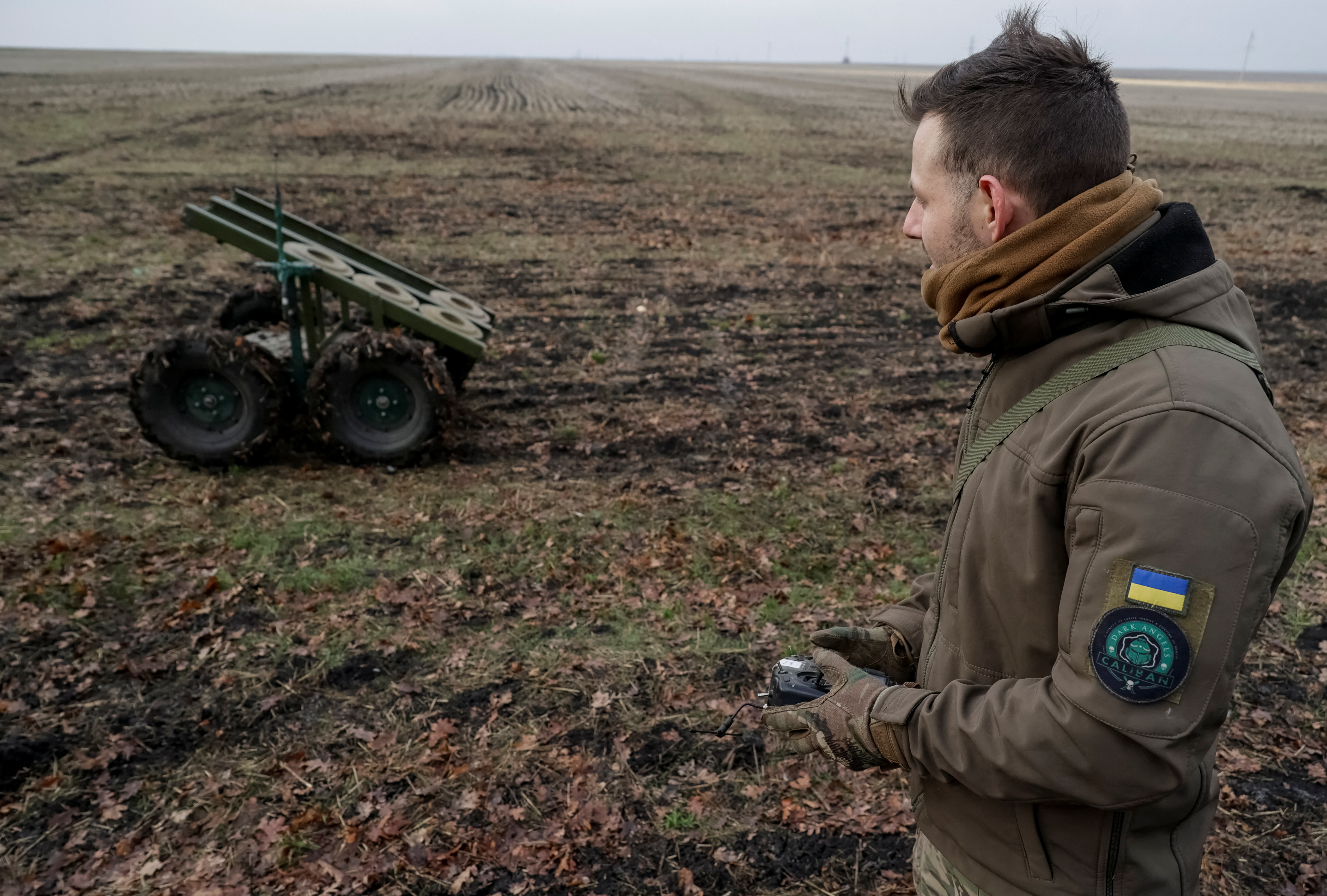 A serviceman of the National Guard of Ukraine operates a mine-laying unmanned ground vehicle in Kharkiv region