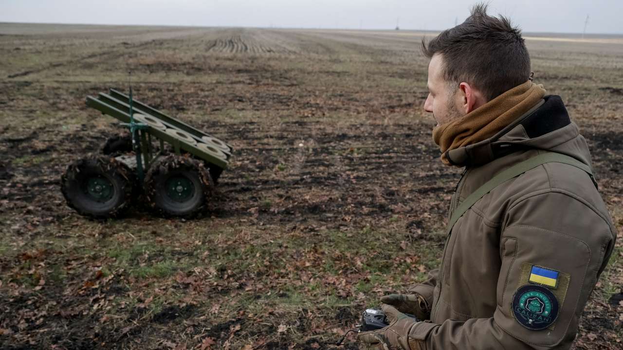 A serviceman of the National Guard of Ukraine operates a mine-laying unmanned ground vehicle in Kharkiv region