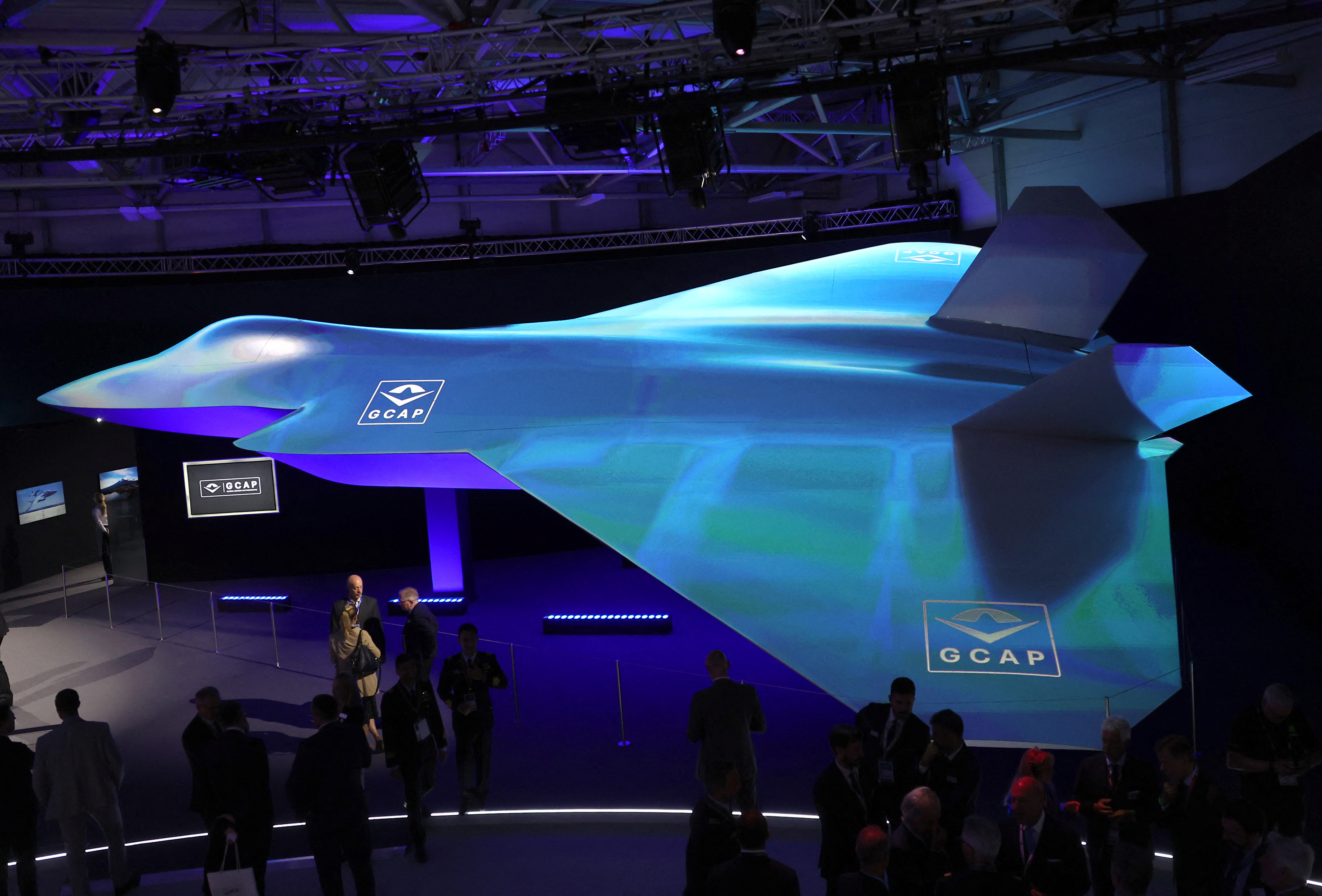 Attendees view GCAP concept fighter plane at the BAE Systems pavilion at Farnborough International Airshow, in Farnborough