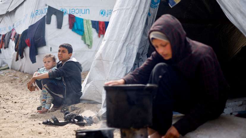 FILE PHOTO: Displaced Palestinians, who fled their houses due to Israeli strikes, shelter at a tent camp, in Rafah