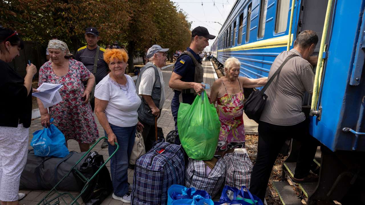 Local residents board an evacuation train as they flee Russian troop advances in Pokrovsk