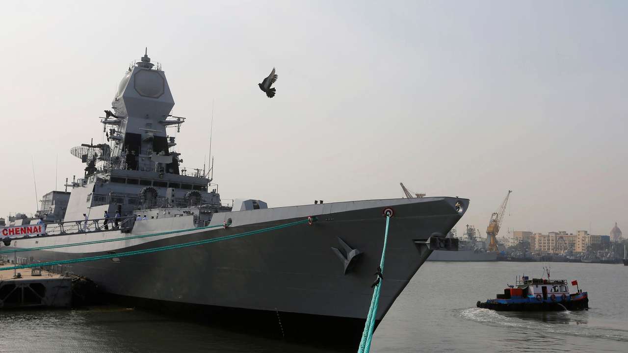 A bird flies past the newly built INS Chennai, India’s third indigenously designed guided missile destroyer, ahead of its commissioning into the Navy in Mumbai