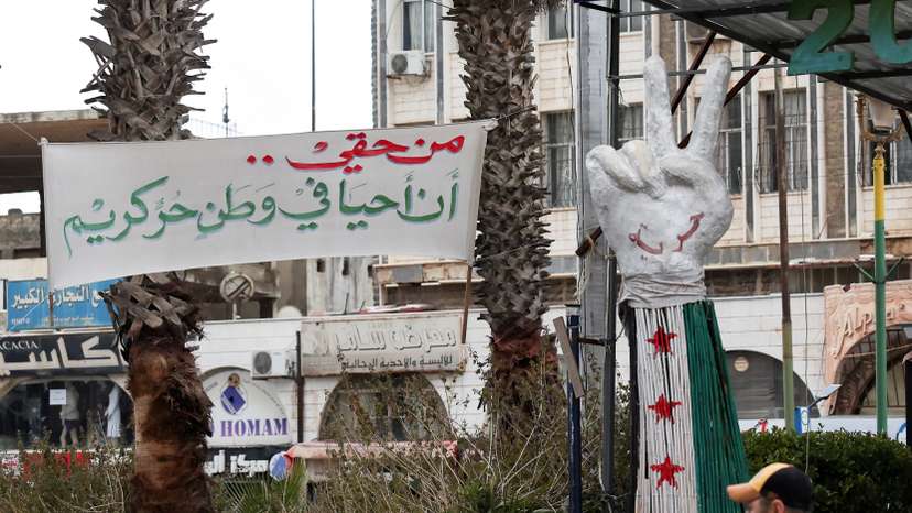 A banner reading "I have the right to live in a free and dignified homeland" is put up at Al-Karama Square in Sweida