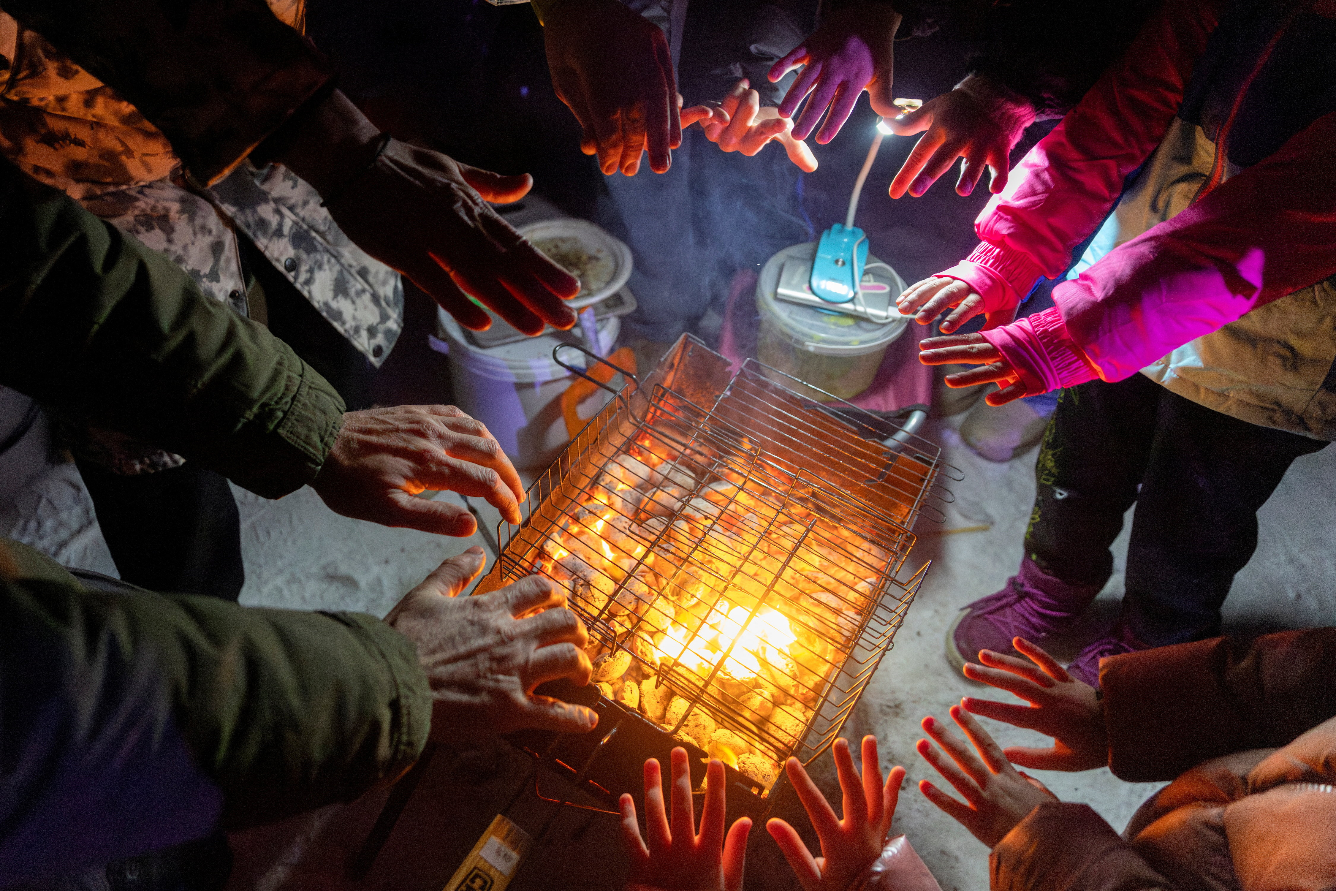 Locals dance the cold away at a blackout party during electricity an outage in Kyiv