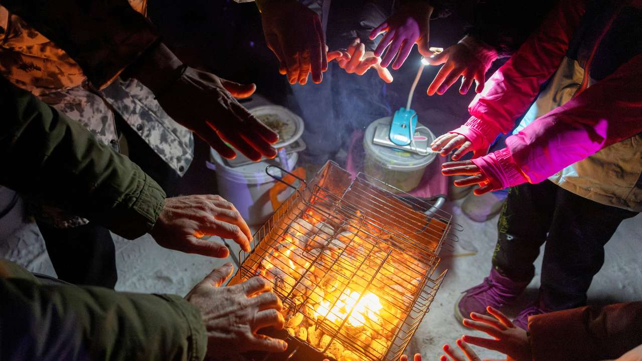 Locals dance the cold away at a blackout party during electricity an outage in Kyiv
