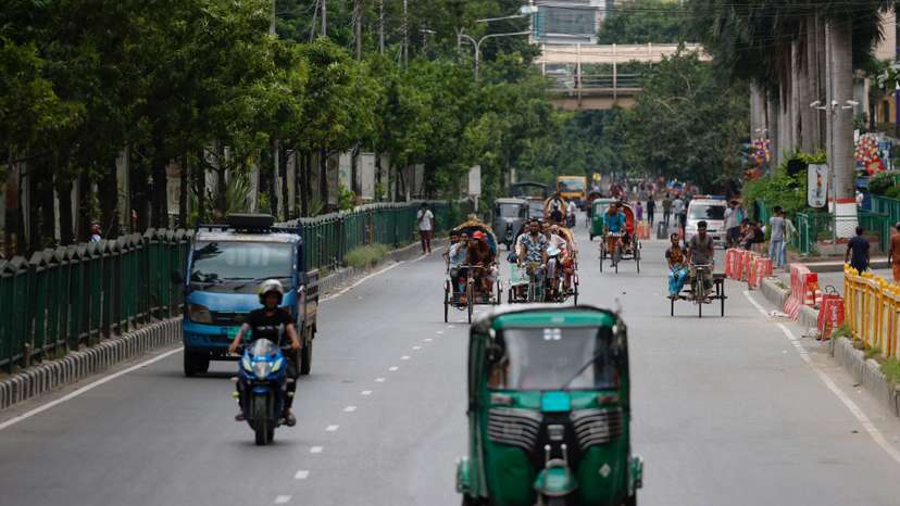 Limited vehicles move on a street on the second-day of curfew, in Dhaka