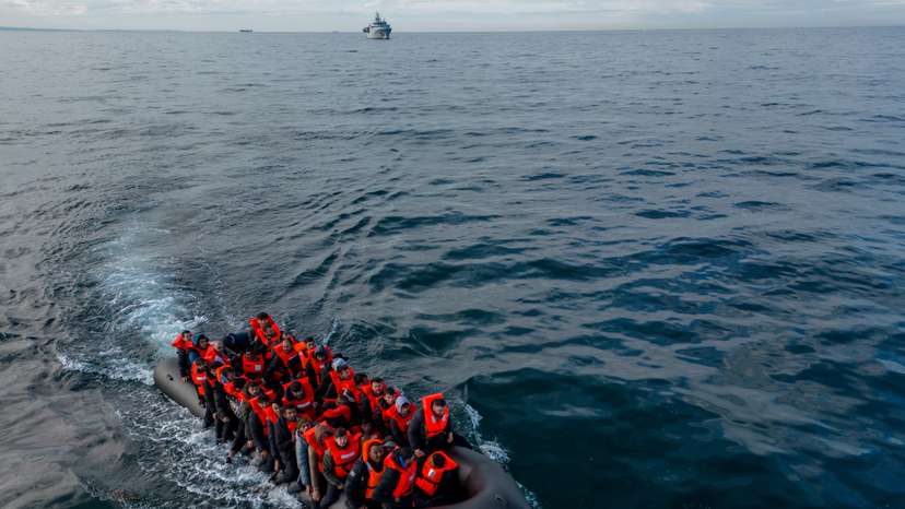 Migrants cross the English Channel in small boats