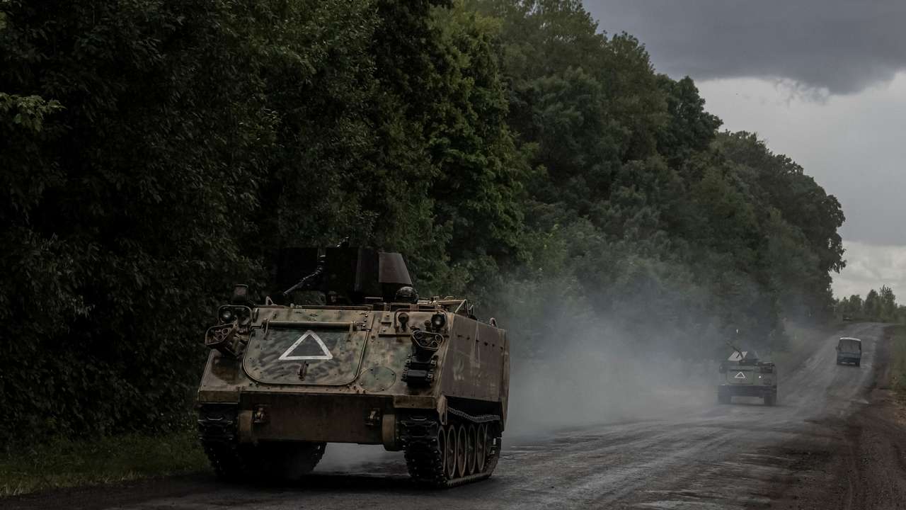 Ukrainian soldiers ride armoured personnel carriers near the Russian border in Sumy region