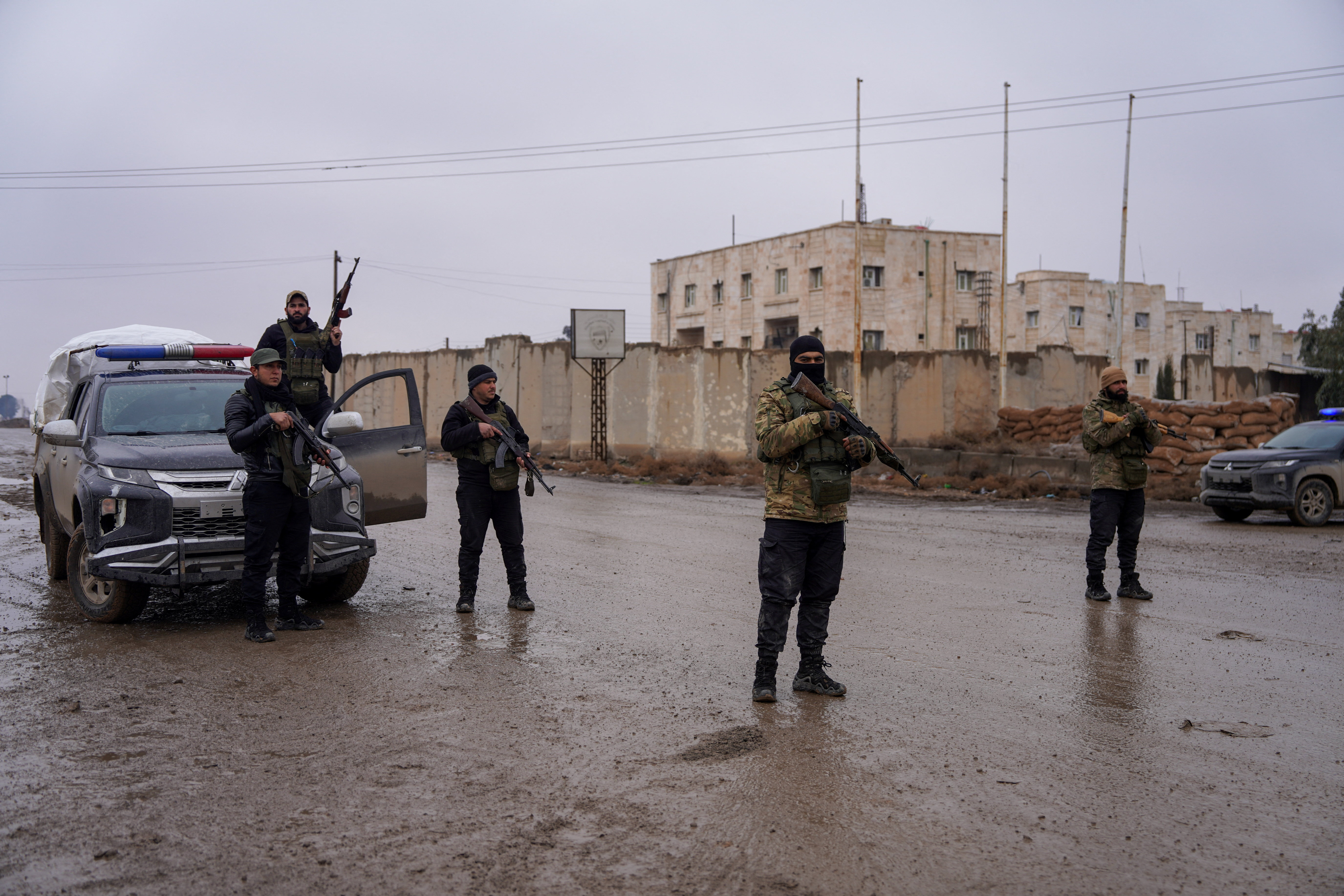 Syrian security forces outside al-Aqtan prison, where some Islamic State detainees are held, in Raqqa