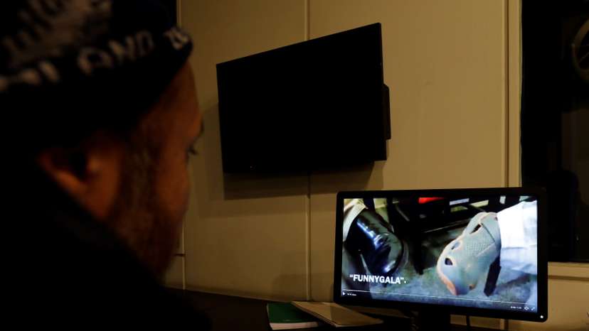 FILE PHOTO: A man looks at a computer screen displaying, what they say is a satire video clip on a social media site, in Islamabad