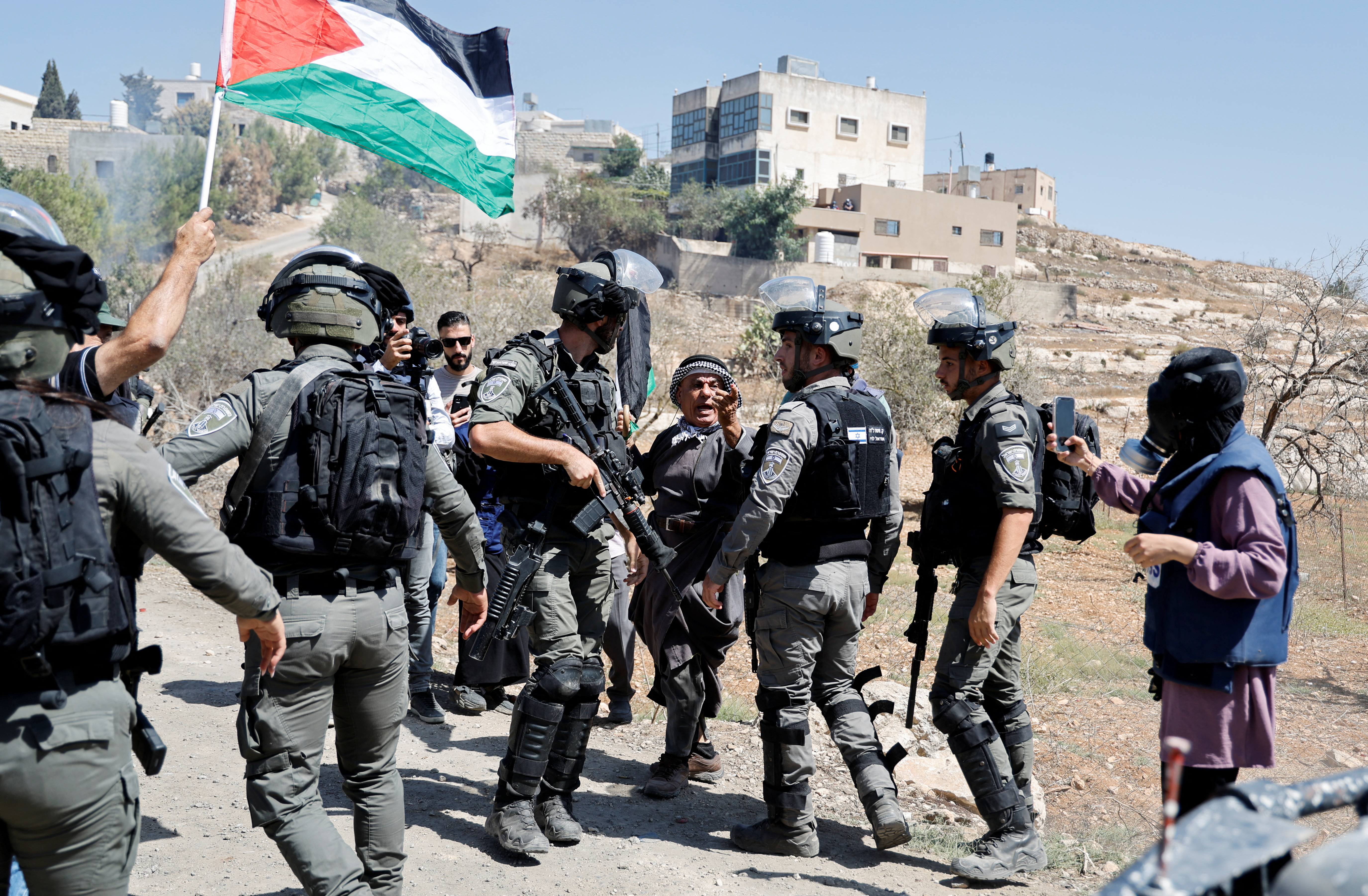 FILE PHOTO: Palestinians react during a protest against Israeli settlements near Nablus