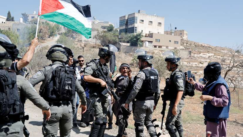 FILE PHOTO: Palestinians react during a protest against Israeli settlements near Nablus