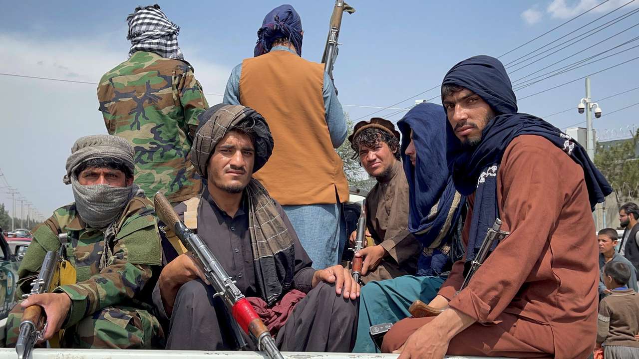 FILE PHOTO: Taliban forces patrol near the entrance gate of Hamid Karzai International Airport, a day after U.S troops withdrawal, in Kabul