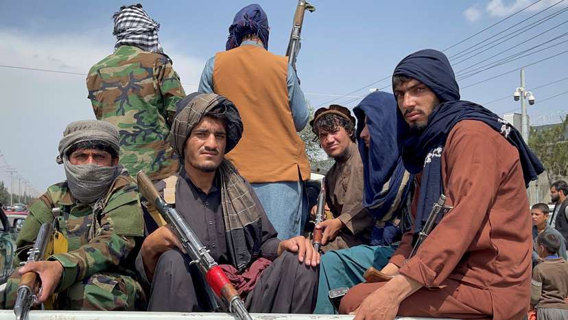 FILE PHOTO: Taliban forces patrol near the entrance gate of Hamid Karzai International Airport, a day after U.S troops withdrawal, in Kabul