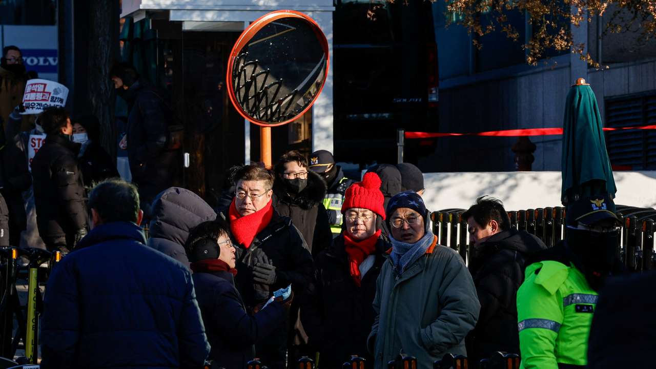 Ruling People Power Party lawmakers stand outside the official residence of impeached South Korean President Yoon Suk Yeol, in Seoul