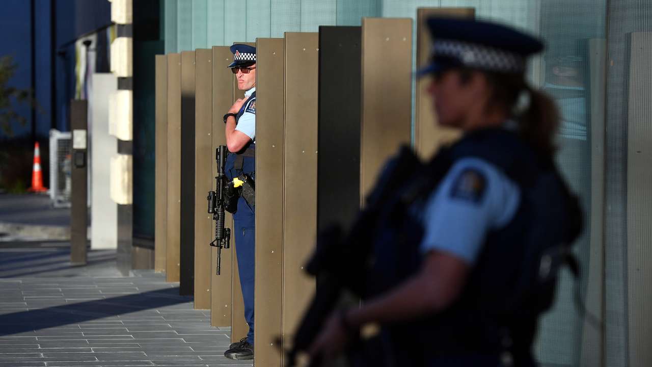 Police officers stay alert during Britain's Prince William's visit to the Justice and Emergency Services Precinct in Christchurch
